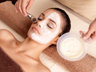The beautician uses a rejuvenating mask